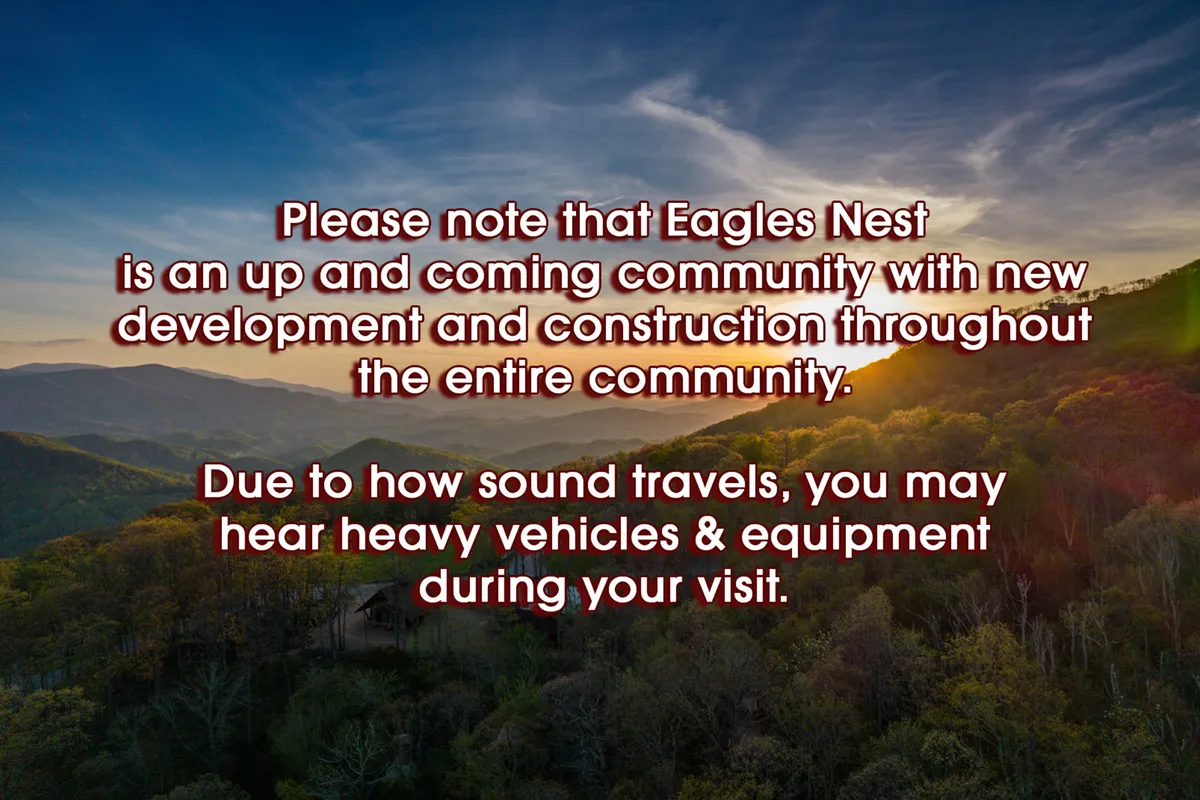 A breathtaking view of a mountain range at sunset, with lush greenery in the foreground. The sweeping panorama conjures the feeling of escape and adventure, and hints at nearby attractions like scenic hikes, waterfalls, and the Eagles Nest Winery.